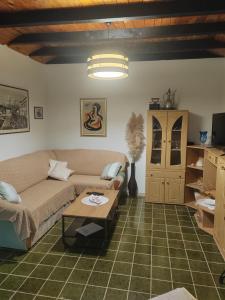 a living room with a couch and a table at Apartmani Ferri 1 in Vrbanj