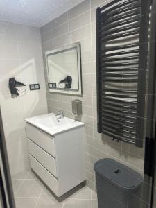a white bathroom with a sink and a mirror at Pilgrims House II in Lourenzá