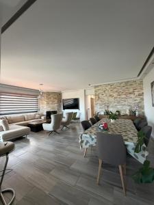 a living room with a couch and a table at ELENA'S VILLA WITH VIEW in Néa Tríglia