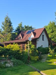 a house with a red roof and a yard at Agroturystyka Kalina Wielka in Kalina Wielka +33 photos