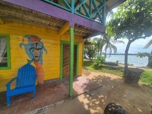 a yellow house with a painting on the side of it at Cabañas T Estefany in Bocas Town