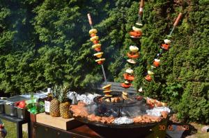 a grill with food on it with a bunch of food at Rezydencja Arabeska in Lądek-Zdrój