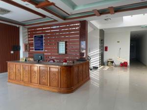 a lobby with a wooden counter in a building at G7 Hotel in Quyền Hoành