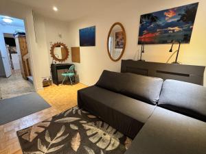 a living room with a couch and a mirror at Montreal Hideaway in a Residential area in Montreal