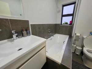 a bathroom with a white sink and a toilet at Galani Homes Comfort 2-Bed Suite in Gaborone
