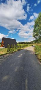 an empty road with a house in the distance at Nest for Rest Nova Varos in Nova Varoš