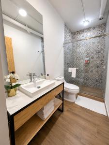 a bathroom with a sink and a toilet at Aloja Rentals Mexico in Mexico City