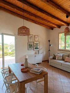 a living room with a table and a couch at Terrazza Ganzaria in San Michele di Ganzaria