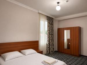 a bedroom with a large bed and a window at Renesans Hotel Kobuleti in Kobuleti +14 photos