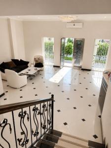 a living room with a black and white tiled floor at Renesans Hotel Kobuleti in Kobuleti