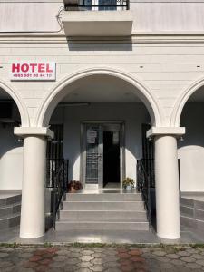 an entrance to a hotel with two arches and stairs at Renesans Hotel Kobuleti in Kobuleti