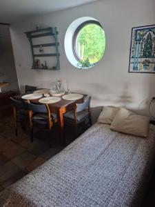 a dining room with a table and a circular window at Agroturystyka Kalina Wielka in Kalina Wielka