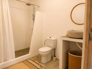 a white bathroom with a toilet and a sink at Pátio 38 do frade in Aldeia do Mato +12 photos