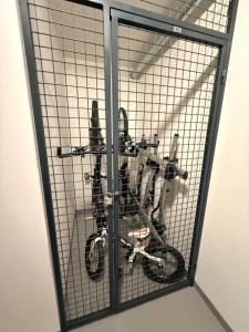 a bike is in a wire cage at Relax in Korzo Lipno in Lipno nad Vltavou +10 photos