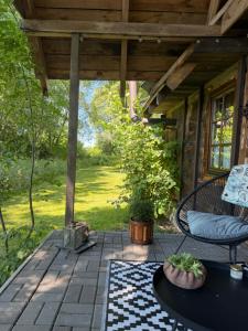 a screened in porch with a bench and a table at Dom nad rzeką in Neple