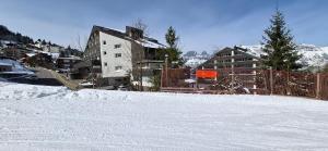 a snow covered slope with buildings in the background at Ferienwohnung in den Flumserbergen in Flumserberg