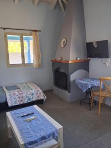 a small room with a bed and a fireplace at La casa di lefki in Elafonisos