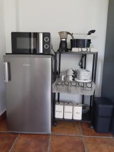 a kitchen with a refrigerator and a microwave at Eguzkitze Habitacion Rural Independiente in Abaltzisketa