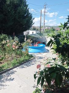 a couple in a blue boat in a garden at Samuela Cozy Retreat in Berat