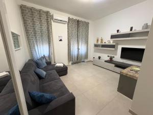 a living room with a couch and a tv at Giusi home in Cologno Monzese