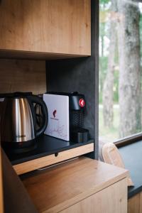 a coffee pot and a box on a kitchen counter at Pinja gozdne hiške in Črniče
