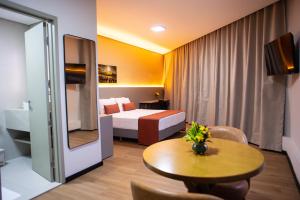 a hotel room with a bed and a table at Petrolina Palace Hotel in Petrolina +20 photos