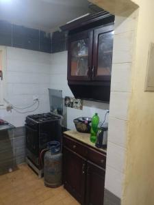 a kitchen with a stove and a counter top at Soukaina home in Sintrīs