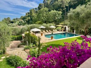 a garden with a swimming pool and purple flowers at Maison Casasand Maison d'hôtes de charme in Grasse +88 photos