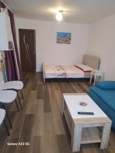 a room with two beds and a table and a couch at Strada Banu Mihalcea Nr. 150 in Constanţa