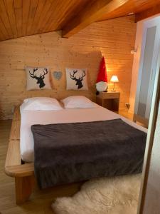 a bedroom with a bed with a santa hat on it at Chalet Les Jouves in Prémanon