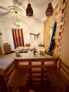 a living room with a table and a couch at Dar Chahla in Tozeur