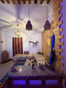 a living room with a couch and a table at Dar Chahla in Tozeur