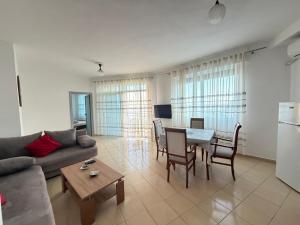 a living room with a couch and a table at SunKissed Apartament in Golem