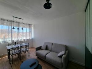 a living room with a couch and a table at Palma 2 in Port-la-Nouvelle