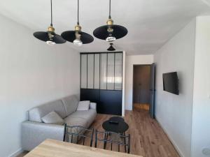 a living room with a couch and a table at Palma 2 in Port-la-Nouvelle