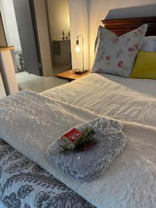 a bed with a blanket and flowers on it at Dune Ridge Cottage in Port Alfred