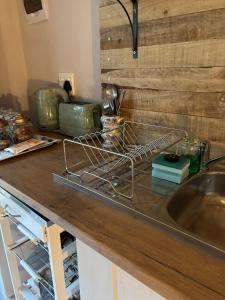 a kitchen counter with a sink and a wooden counter top at Dune Ridge Cottage in Port Alfred +11 photos