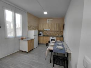 a kitchen with a table and chairs and a kitchen with a counter at Rua de Galicia 2 in Ribeira