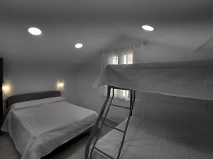 a bedroom with two bunk beds and a window at Rua de Galicia 2 in Ribeira