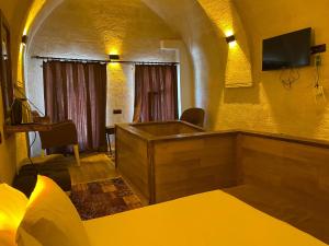 a room with a tub in the middle of a room at Masal Cave Suites - Where Story Begins in Ürgüp