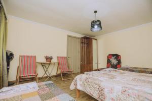a bedroom with two beds and a table and chairs at Qiwi House in Ureki +26 photos