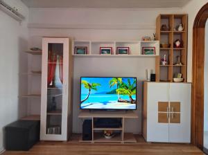 a living room with a flat screen tv sitting on a shelf at Rafa´s house in Selca