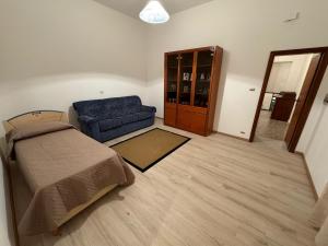 a living room with a bed and a couch at Casa della nonna in Donisi