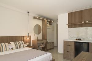 a bedroom with a bed and a desk and a kitchen at Amalia Apartments-Suites in Bali +88 photos