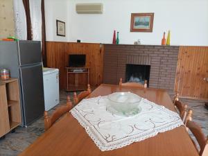 a dining room with a table and a fireplace at Casa della nonna in Donisi