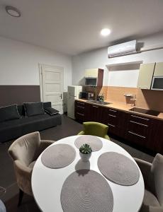 a living room with a table and a kitchen at Apartma 2 in Pekre
