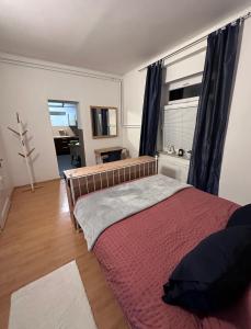 a bedroom with a large bed with a red blanket at Apartma 2 in Pekre