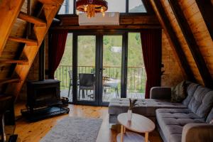 a living room with a couch and a fireplace at Danzi camping tiny house in Kise