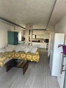 a living room with a bed and a refrigerator at jesolo wellness house in Lido di Jesolo