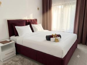 a bedroom with a large bed with a gift on it at A-frame-WHITE HOUSE-I in Qusar +6 photos